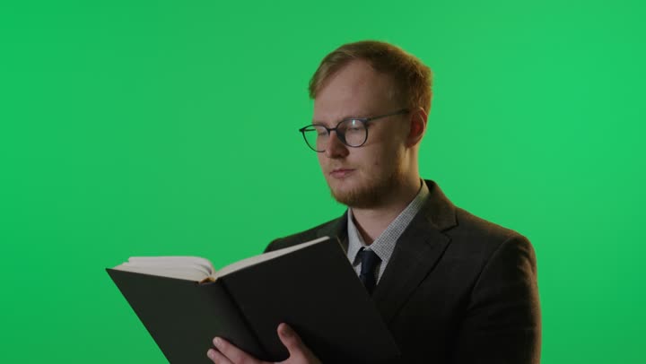 Man Reading Book on Green Screen Background Studio