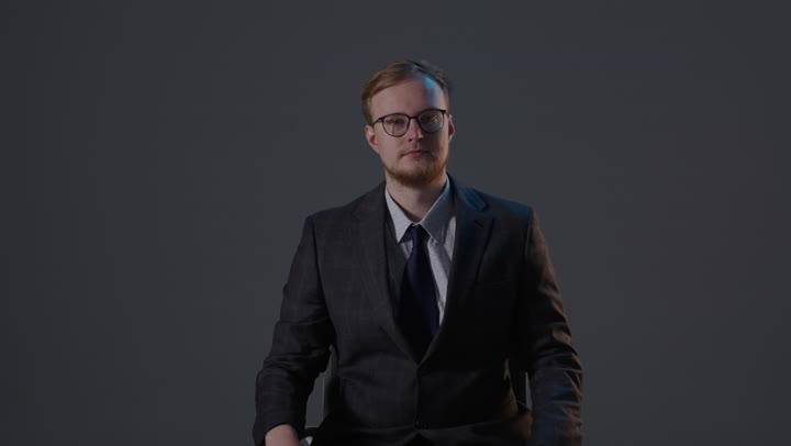 Businessman Giving Thumbs Up in Studio Setting