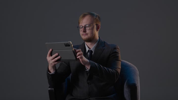 Businessman Using Tablet in Dark Studio Footage