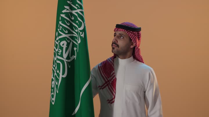 Saudi Man Standing with Saudi Arabia Flag Portrait