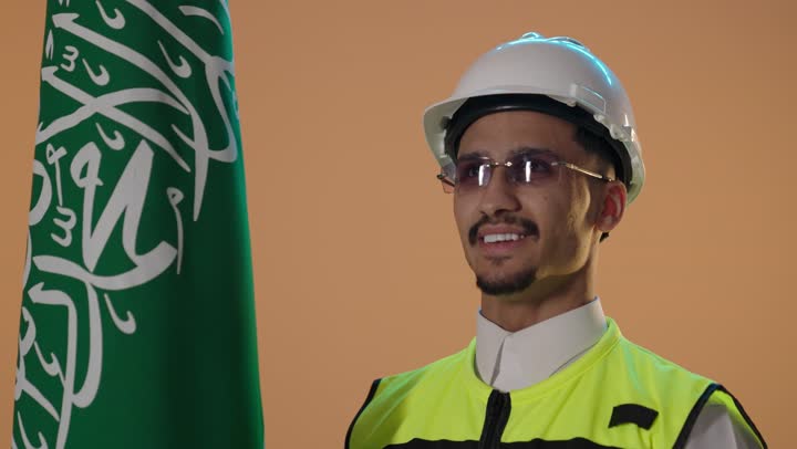 بورتريه مهندس سعودي مع العلم في الاستوديو