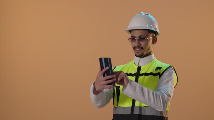 Saudi Engineer Using Smartphone in Studio Setting