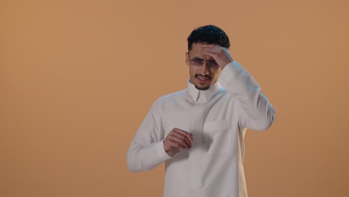 Saudi Man in Thobe Expressing Headache Stress Studio