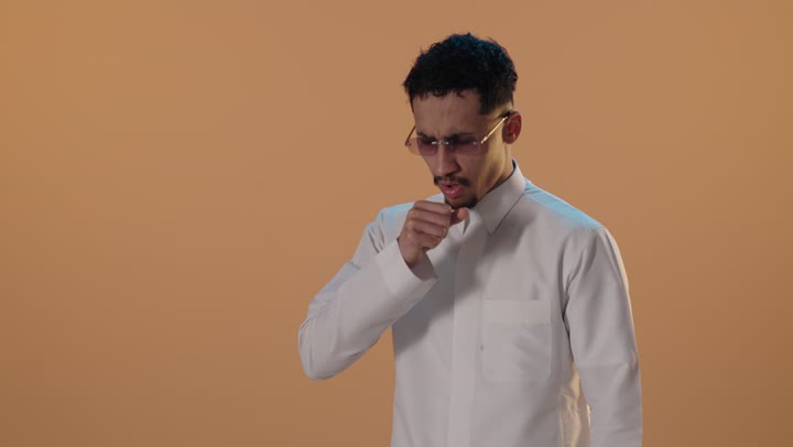 Saudi Man in Thobe Coughing in Studio