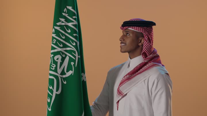 رجل سعودي مع العلم الوطني في الاستوديو