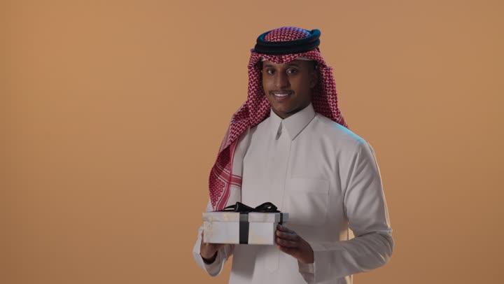 Saudi Man Holding Gift Box in Studio Portrait Footage