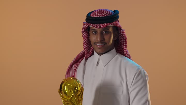 Saudi Man Holding Gold Football Trophy Studio Video