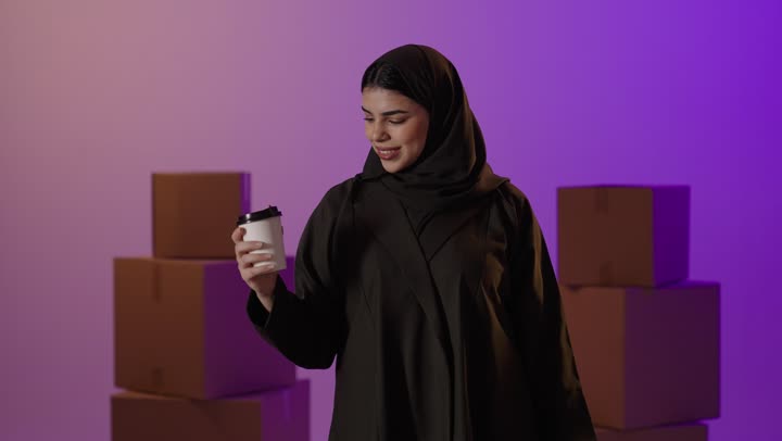 Arab Woman with Shopping Bags and Coffee in Studio