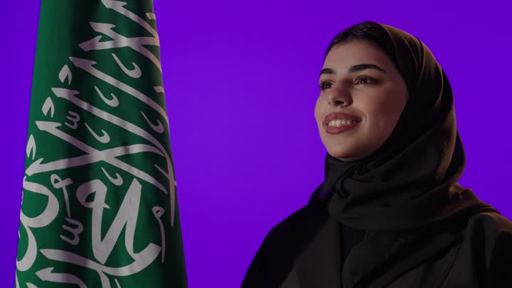 Saudi Woman Smiling with National Flag Studio Shot
