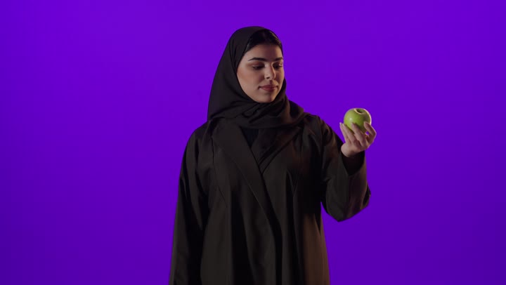 Saudi Woman with Green Apple Thumbs Up Studio Video