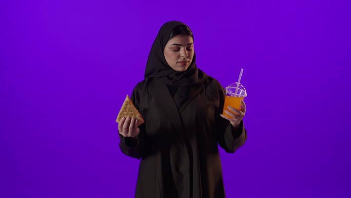 Saudi Woman Holding Pizza and Orange Juice Studio Shot