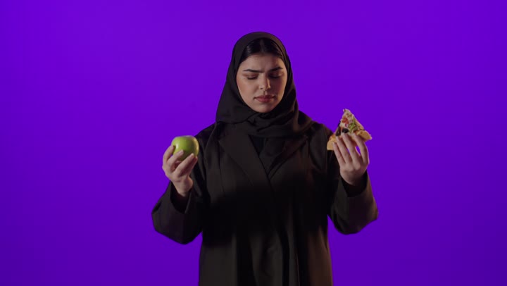 Arab Woman Choosing Green Apple Over Pizza Studio Video
