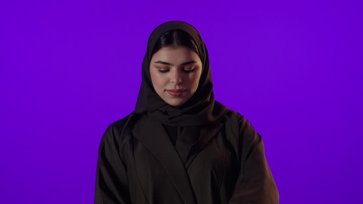 Saudi Woman Opening Pizza Box on Purple Background