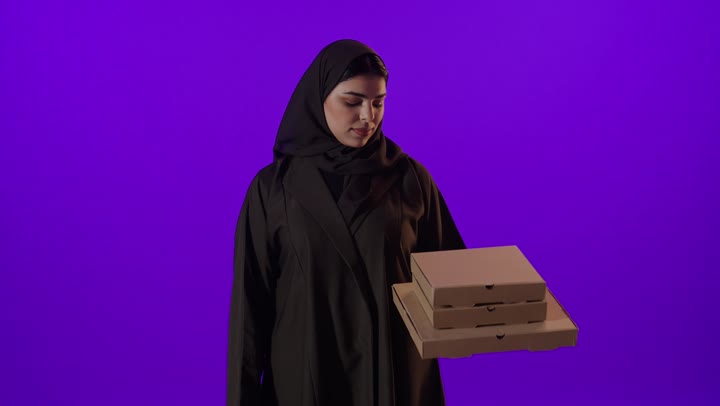 Saudi Woman Holding Pizza Boxes Purple Background
