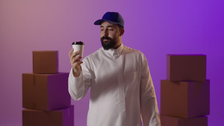 Saudi Delivery Courier Holding Coffee and Shopping Bags