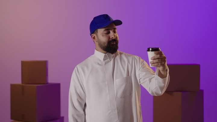 Saudi Delivery Man Holding Coffee Giving Thumbs Up