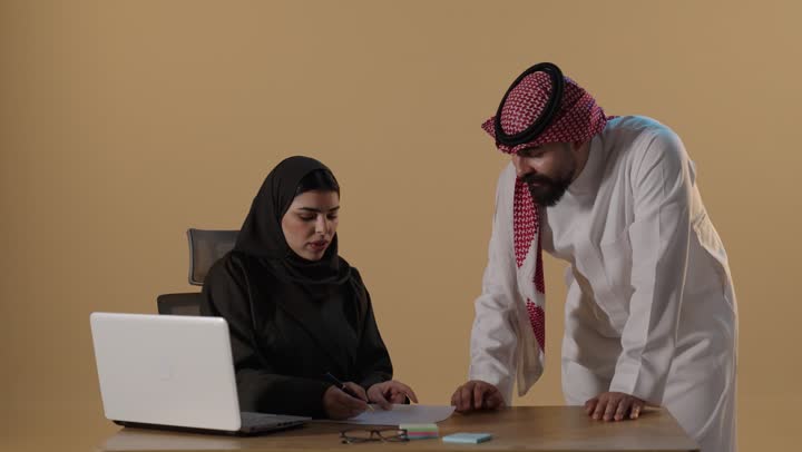 Saudi Business People Working and Signing Documents