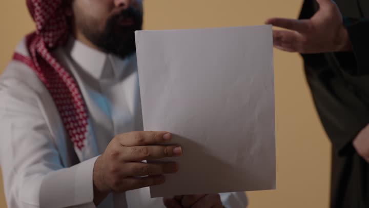 Saudi Man Holding Blank White Paper Studio Footage