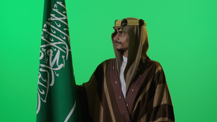 Saudi Man in Traditional Attire with Flag Green Screen