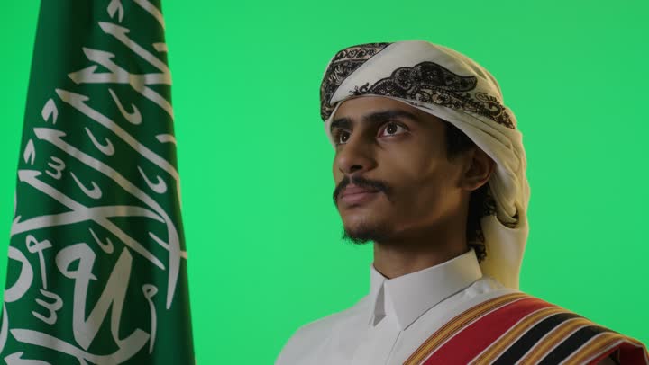 Saudi Man in Traditional Dress with Flag Green Screen