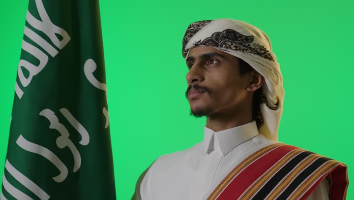 Saudi Man with National Flag on Green Screen