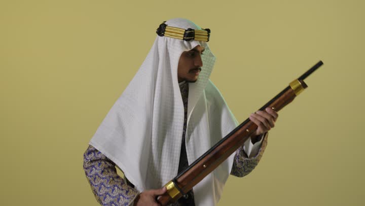 Saudi Man in Traditional Founding Day Attire with Rifle