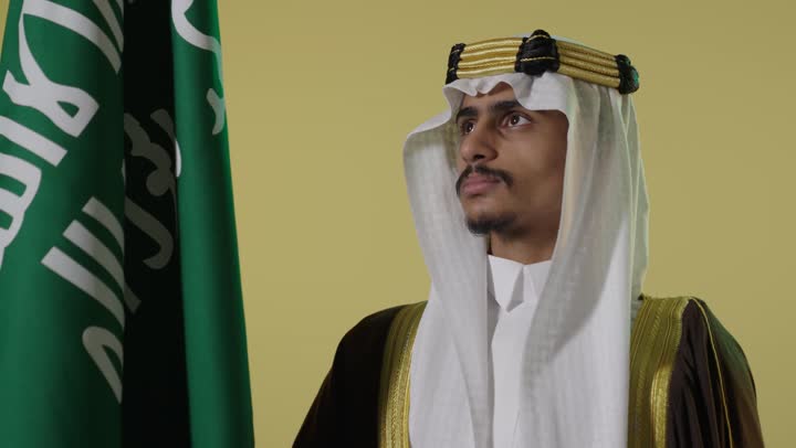 Saudi Man in Traditional Dress with Flag Founding Day