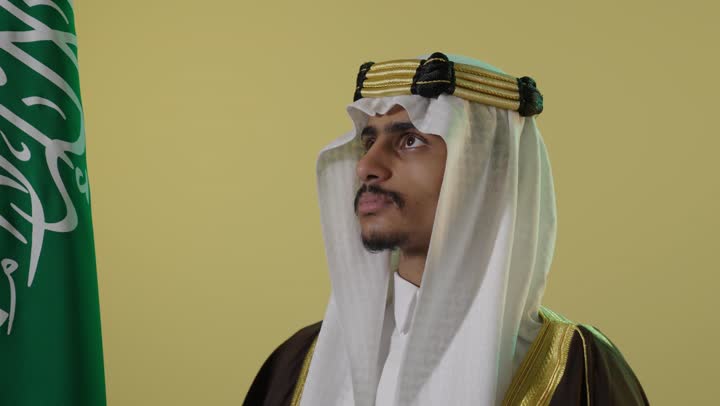Saudi Man in Traditional Bisht with National Flag