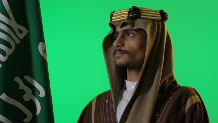 Saudi Man in Traditional Heritage Dress with Flag