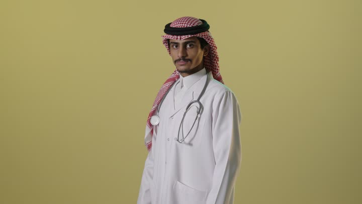 Saudi Male Doctor Crossing Arms in Studio Portrait