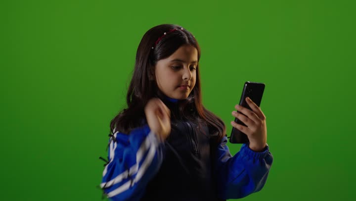 Girl Using Smartphone on Green Screen Background