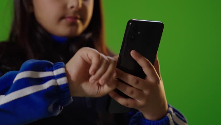 Girl Using Smartphone on Green Screen Background