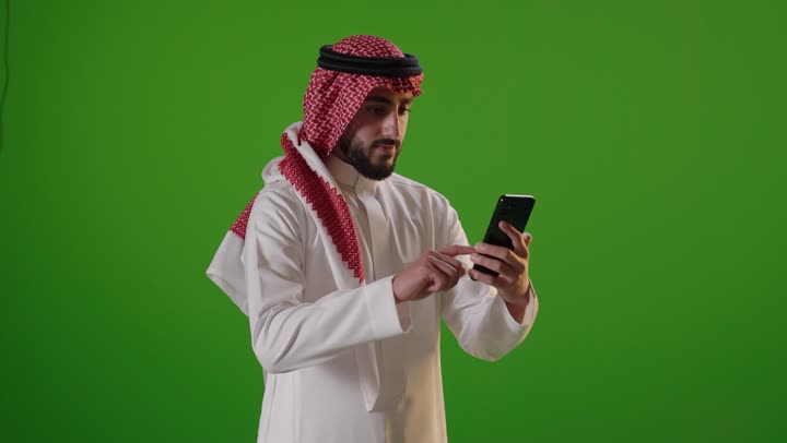 Saudi Man Using Smartphone on Green Screen