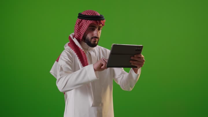 Saudi Man Using Tablet on Green Screen Studio