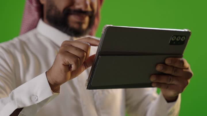Saudi Man Using Digital Tablet on Green Screen
