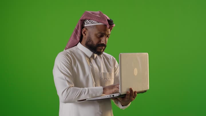 Arab Man Using Laptop on Green Screen Chroma Key