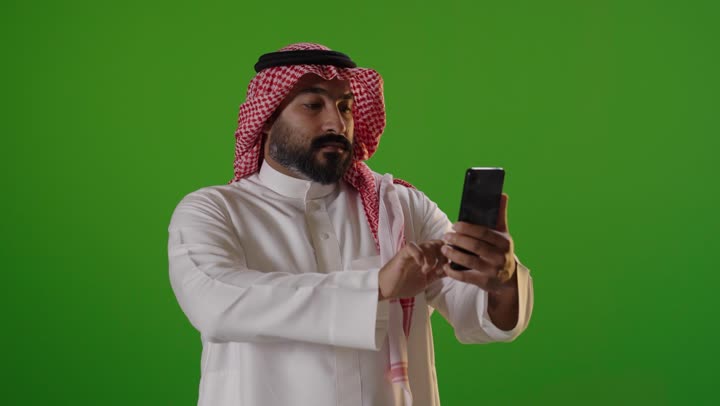 Saudi Man Using Smartphone on Green Screen