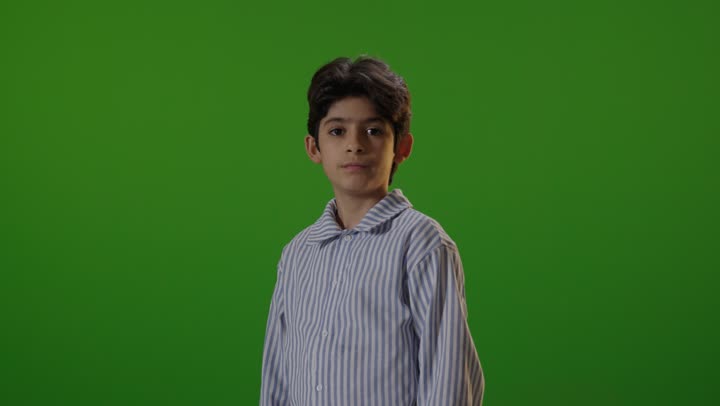 Smiling Boy in Pajamas on Green Screen Studio Footage