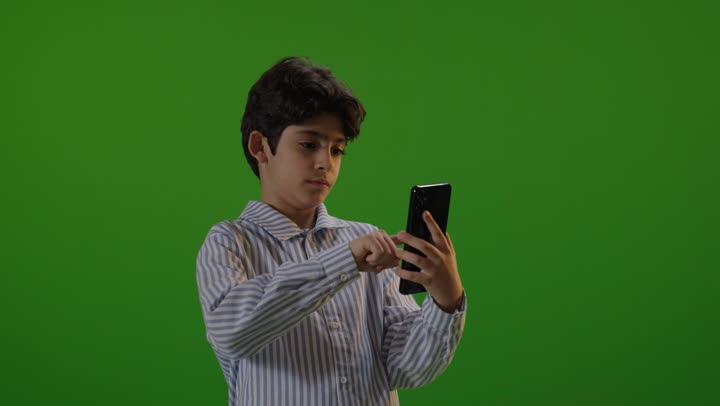 Boy Using Smartphone on Green Screen Background