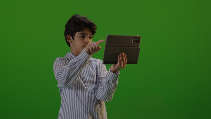 Boy Using Tablet on Green Screen Chroma Key Background