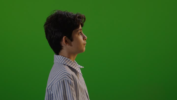 Arab Boy Turning and Smiling on Green Screen Studio Footage