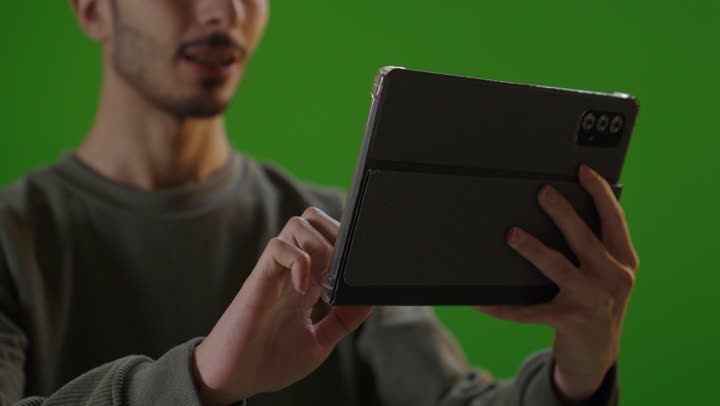 Man Using Tablet on Green Screen Studio Footage
