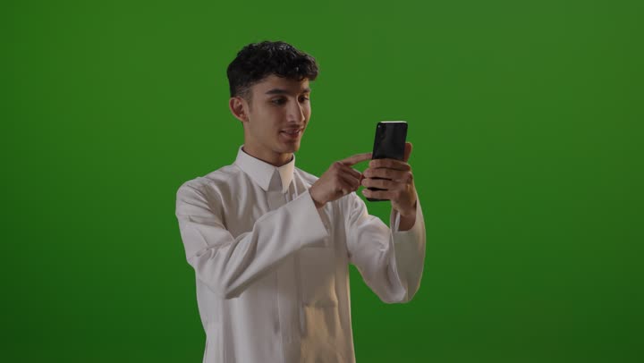 Arab Man Using Smartphone on Green Screen Background