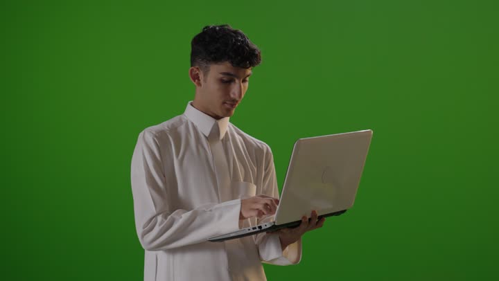 Saudi Student Using Laptop on Green Screen Chroma Key