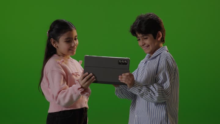 Children Using Tablet Device on Green Screen Background