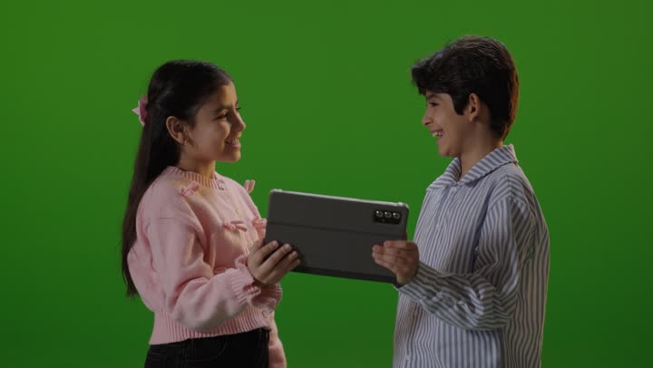 Children Using Tablet on Green Screen Background