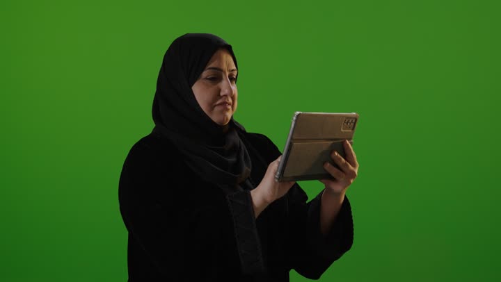 Arab Woman Using Digital Tablet on Green Screen