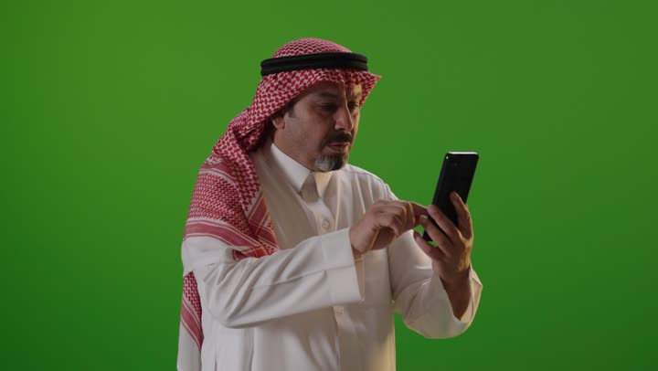 رجل سعودي يستخدم الهاتف الذكي بخلفية كروما