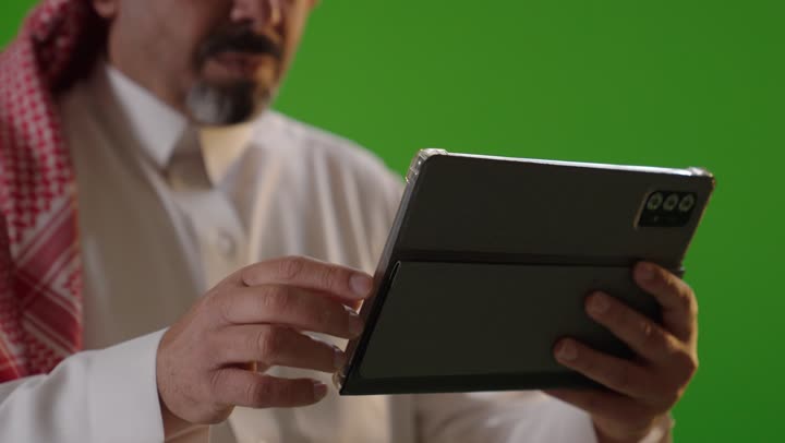 Saudi Man Using Tablet on Green Screen Chroma Key