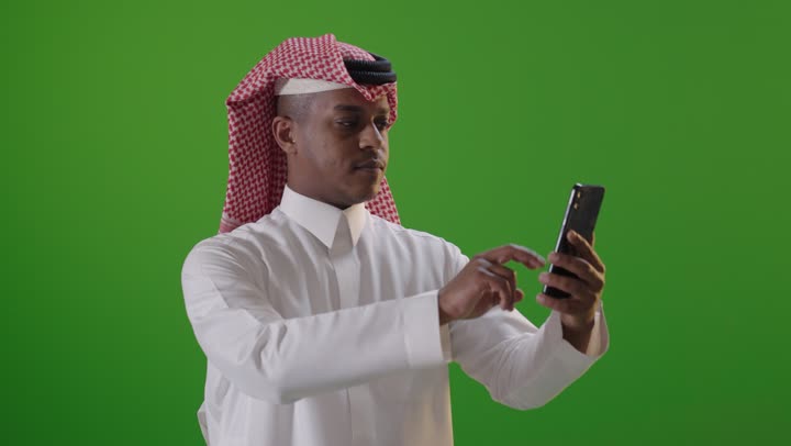 Saudi Man Using Smartphone on Green Screen
